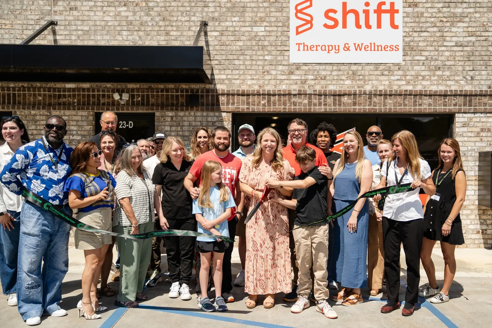 Shift Therapy & Wellness team and community members at a local ribbon-cutting event
