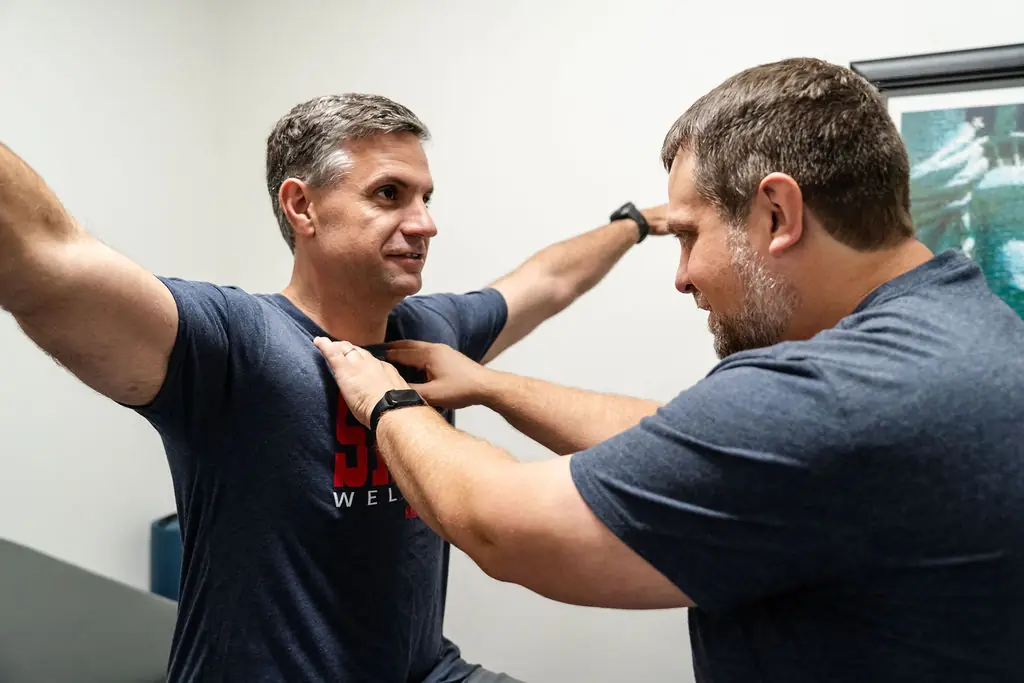 Physical therapist assessing a patient's shoulder mobility after reverse shoulder replacement at Shift Therapy & Wellness in Rome, GA